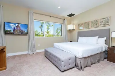 a bedroom with a large bed and a window at Beautiful Magic Village 4 Suites near Disney 7493 in Orlando