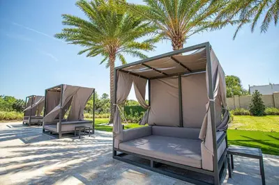 two beds are lined up next to palm trees at Beautiful Magic Village 4 Suites near Disney 7493 in Orlando
