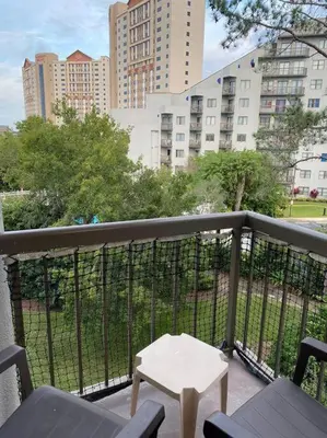 a balcony with a table and chairs and buildings at Spacious Studio close to Theme Parks in Orlando