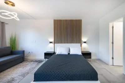 a bedroom with a bed and a couch at Spacious Studio close to Theme Parks in Orlando
