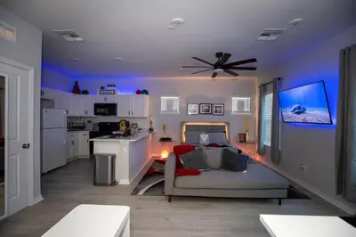 a living room with a couch and a ceiling fan at Pet Friendly Modern Zen Studio Retreat with Hot Tub! home in Orlando