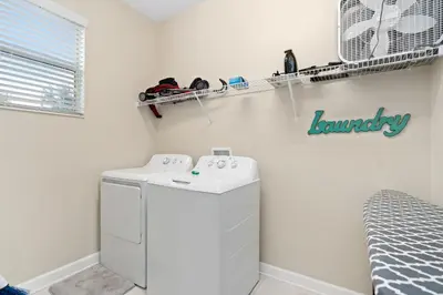 a laundry room with a washer and dryer at Storey Lake -6 Bedrooms Luxury home w-pool & spa in Kissimmee