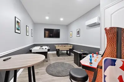 a play room with a table and a chessboard at Storey Lake -6 Bedrooms Luxury home w-pool & spa in Kissimmee