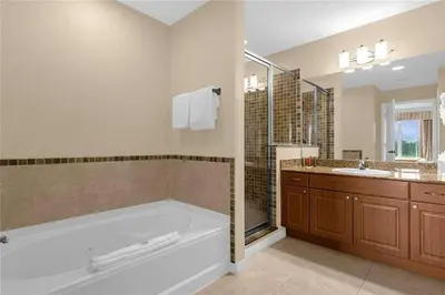 a large bathroom with a tub and a sink at Premier Resort Condos Near Disney & Universal in Orlando