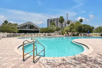 a swimming pool with blue water in a resort at Cozy Condo on International Dr. Near Universal Studios in Orlando