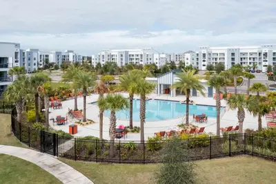 an aerial view of a resort with a pool and palm trees at Family Friendly 2 Bd Close to Disney @ Storey Lake 105 3161 in Kissimmee