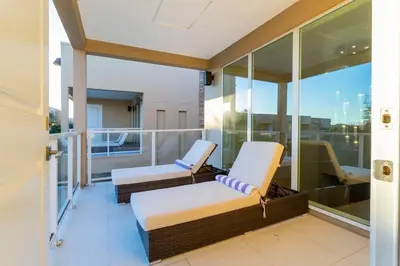 a balcony with two chairs and a couch at Stunning 4Bd Close to Disney @ Magic Village 7614 in Orlando