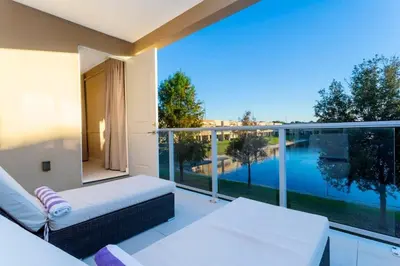 a balcony with a couch and a view of the water at Stunning 4Bd Close to Disney @ Magic Village 7614 in Orlando