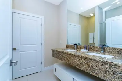 a bathroom with two sinks and a large mirror at Stunning 4Bd Close to Disney @ Magic Village 7614 in Orlando