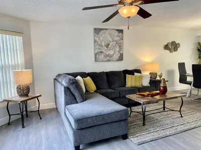 a living room with a couch and a table at Grand Family 3BR Condo Apartment near Disney Parks in Kissimmee