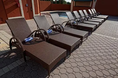 a row of chairs sitting next to a pool at Westgate Towers Resort in Orlando