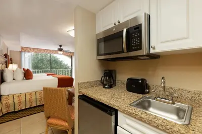 a kitchen with a sink and a bed in a room at Westgate Towers Resort in Orlando