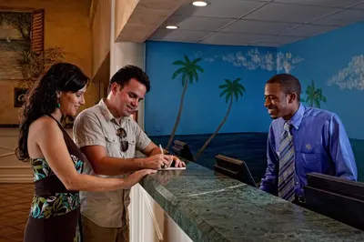 a group of people standing around a counter at Westgate Towers Resort in Orlando