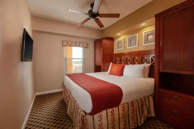 a bedroom with a large bed with a ceiling fan at Westgate Town Center Resort in Orlando