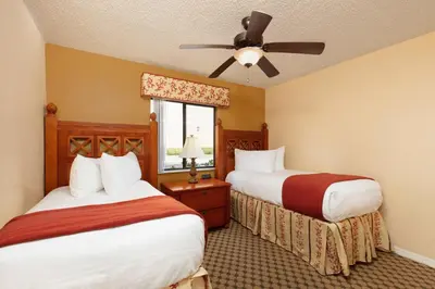 a hotel room with two beds and a ceiling fan at Westgate Vacation Villas Resort in Orlando