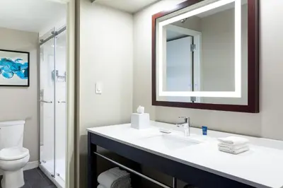 a bathroom with a sink and a mirror at Four Points by Sheraton Orlando Convention Center in Orlando
