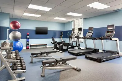 a gym with several treadmills and cardio machines at Four Points by Sheraton Orlando Convention Center in Orlando