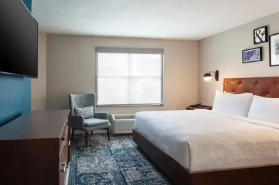a hotel room with a bed and a chair at Four Points by Sheraton Orlando Convention Center in Orlando