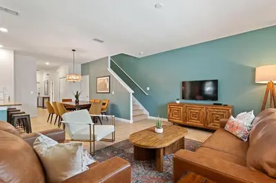 a living room with a couch and a tv at Refurbished! Lazy Life At Storey Lake By Shine Villas #901 in Kissimmee
