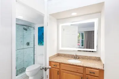 a bathroom with a sink and a toilet and a mirror at Westgate Blue Tree Resort in Orlando