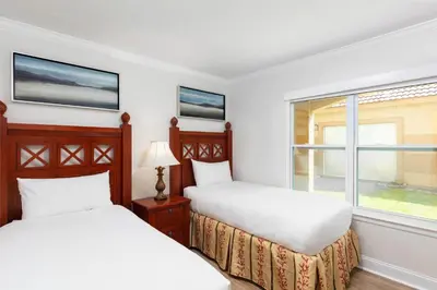 two beds in a room with a window at Westgate Blue Tree Resort in Orlando