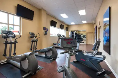 a gym with treadmills and ellipticals in a room at Westgate Palace Hotel - Universal - I-Drive in Orlando