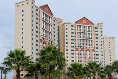 a large building with palm trees in front of it at Westgate Palace Hotel - Universal - I-Drive in Orlando