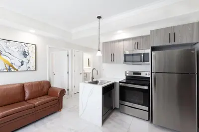 a kitchen with a couch and a stainless steel refrigerator at Westgate Palace Hotel - Universal - I-Drive in Orlando