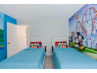 two beds in a room with a mural on the wall at Best place to unwind and have lots of fun! in Kissimmee