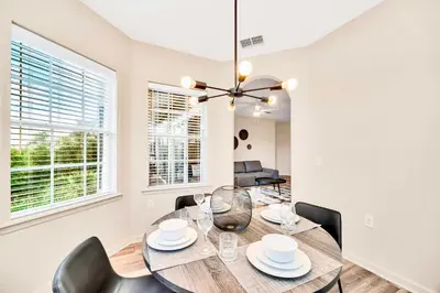 a dining room with a table and chairs at Upstay Condo with Outdoor Pool & Sauna in Orlando