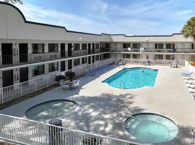 a view of a pool in front of a hotel at Stayable Kissimmee West in Kissimmee