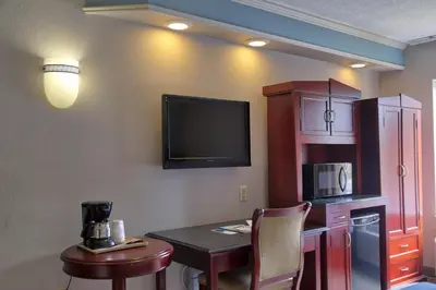 a room with a table and a tv on the wall at Destiny Palms Hotel Maingate West in Kissimmee