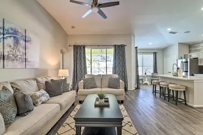 a living room with a couch and a table at 5 Mi to Disney World Retreat with Pool and Lanai! in Kissimmee