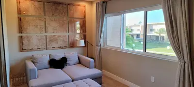 a cat sitting on a couch in a room with a window at Magic Village 4 Bedroom! Welcome Home! in Orlando