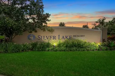 a sign for a silver lake resort with a lawn at Silver Lake Resort in Orlando