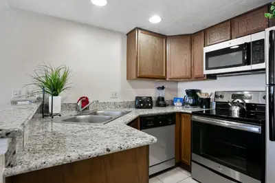a kitchen with a sink and a stove at Silver Lake Resort in Orlando