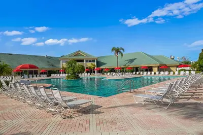 a large swimming pool with chairs in a resort at Silver Lake Resort in Orlando
