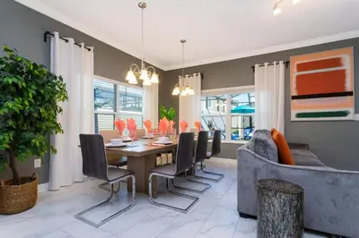 a dining room with a table and chairs and a couch at Wonderful 5 Bd Close to Disney @ Storey Lake Resort 2980 in Kissimmee