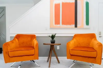two orange chairs in a room with a table at Wonderful 5 Bd Close to Disney @ Storey Lake Resort 2980 in Kissimmee