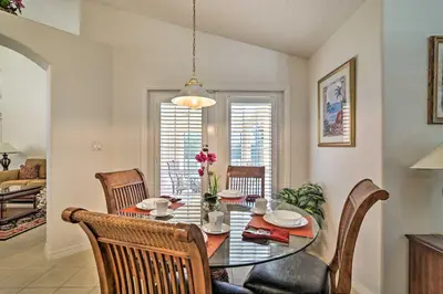a dining room with a table and chairs at No Pet Fee! Snowbird Haven in Lake Worth Beach! in Orlando