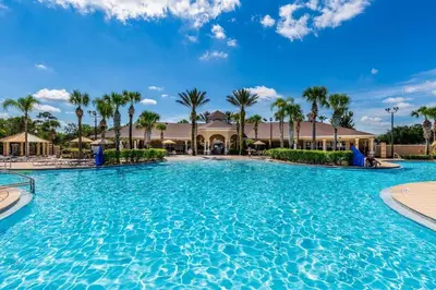 a large pool at a resort with palm trees at 3 bedroom Disney Condo Windsor Hills in Orlando