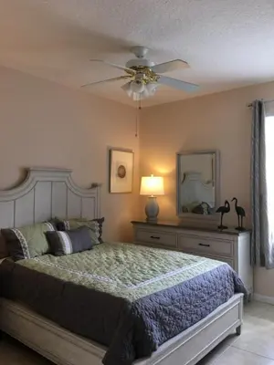 a bedroom with a bed and a ceiling fan at Resort 5 Bed Private Pool & Spa, Game Room Home villa in Kissimmee