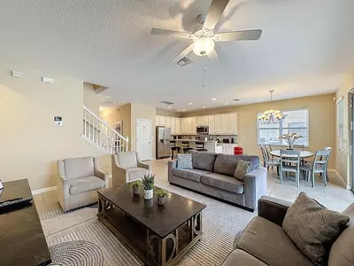 a living room with a couch and a table at Veranda Home, 8br, 6 en-suites, Lake View,POOL SPA villa in Kissimmee
