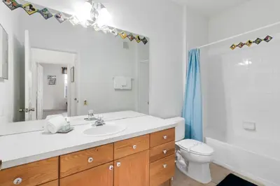 a bathroom with a sink and a toilet and a mirror at Amazing Resort 2 bed condo close to Disney condo in Kissimmee