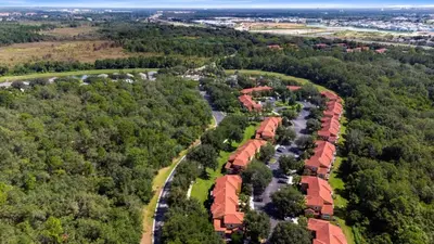 an aerial view of a house with trees at Disney Area 4 bed 3,5 Bathroom Emerald Island townhouse in Kissimmee
