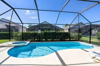 a swimming pool in front of a house at Fantastic Resort 5BR House - South Facing Pool Spa villa in Kissimmee