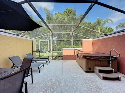 a large patio with a hot tub and benches at Amazing Townhouse close to Disney 2 Bed 2,5 Bath townhouse in Kissimmee