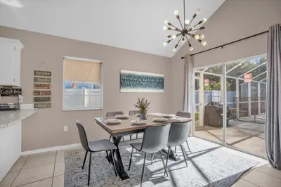 a dining room with a table and chairs at Elegant Villa Pool Fun Game Room Near Disney in Kissimmee