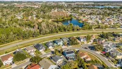 an aerial view of a neighborhood with houses and a lake at Elegant Villa Pool Fun Game Room Near Disney in Kissimmee