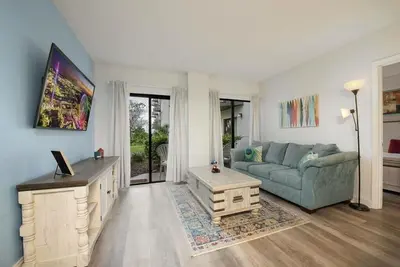 a living room with a couch and a table at Exclusive Ground-Floor Apartment in Orlando